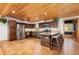 Kitchen with stainless appliances, granite countertops, wood cabinets and breakfast bar with seating at 24030 San Isabel Rd, Indian Hills, CO 80454