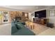 Inviting living room featuring a stone fireplace, large TV, and comfortable seating at 24030 San Isabel Rd, Indian Hills, CO 80454