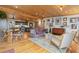 Open concept living room with wooden ceiling and floors, sofa, and access to the kitchen at 24030 San Isabel Rd, Indian Hills, CO 80454