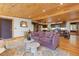 Spacious living room with access to kitchen, wood floors, and an open layout, perfect for entertaining at 24030 San Isabel Rd, Indian Hills, CO 80454