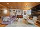 Bright living room with wooden ceiling, fireplace, stylish decor and comfortable seating at 24030 San Isabel Rd, Indian Hills, CO 80454