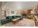 Inviting living room featuring a stone fireplace, large TV, and comfortable seating at 24030 San Isabel Rd, Indian Hills, CO 80454