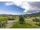 Scenic neighborhood view overlooks the surrounding landscape with trees and clear skies at 24030 San Isabel Rd, Indian Hills, CO 80454