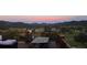 Covered deck with patio furniture and a sunset view, featuring a peaceful and inviting outdoor space at 24030 San Isabel Rd, Indian Hills, CO 80454