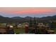 Covered deck with patio furniture and a mountain view, featuring a peaceful and inviting outdoor space at 24030 San Isabel Rd, Indian Hills, CO 80454