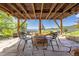 Cozy outdoor patio features a stone fire pit with seating and a scenic mountain backdrop at 24030 San Isabel Rd, Indian Hills, CO 80454