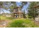 Backyard playhouse with ladder, elevated platform and Colorado flag at 24030 San Isabel Rd, Indian Hills, CO 80454