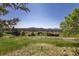 Expansive scenic view showcases rolling hills and a picturesque neighborhood landscape at 24030 San Isabel Rd, Indian Hills, CO 80454