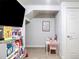 Cozy basement featuring a desk, books, and a playful learning environment at 181 S Monaco Pkwy, Denver, CO 80224