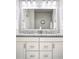 Bathroom featuring double sinks, granite countertops, a large mirror, and modern lighting fixtures at 181 S Monaco Pkwy, Denver, CO 80224