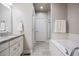 Bathroom featuring a bathtub, vanity with granite top, and a glass-enclosed shower at 181 S Monaco Pkwy, Denver, CO 80224