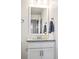 Bright bathroom featuring a granite countertop vanity, modern mirror, and chrome fixtures at 181 S Monaco Pkwy, Denver, CO 80224