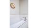 Relaxing soaking bathtub featuring white subway tiles, chrome fixtures, and modern decor at 181 S Monaco Pkwy, Denver, CO 80224