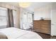 Bright bedroom features a large dresser, windows with blinds, and modern decor for a comfortable space at 181 S Monaco Pkwy, Denver, CO 80224