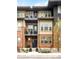 Multi-story home with a mix of brick and siding, featuring balconies and lush landscaping at 181 S Monaco Pkwy, Denver, CO 80224