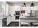 Modern kitchen with white cabinets, stainless steel appliances, granite counters, and island seating at 181 S Monaco Pkwy, Denver, CO 80224