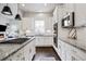 Bright, open kitchen featuring white cabinets, granite countertops, and stainless steel appliances at 181 S Monaco Pkwy, Denver, CO 80224