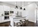 Modern kitchen with white cabinets, stainless steel appliances, granite counters, and island seating at 181 S Monaco Pkwy, Denver, CO 80224