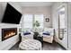 Cozy living room with a modern fireplace, comfortable seating, and a bright ambiance at 181 S Monaco Pkwy, Denver, CO 80224