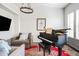 Elegant living room with a grand piano, comfortable seating, and stylish decor at 181 S Monaco Pkwy, Denver, CO 80224