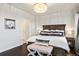 Elegant main bedroom with dark wood furniture, a decorative chandelier, and stylish bedding at 181 S Monaco Pkwy, Denver, CO 80224