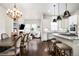 Open floor plan showcasing the dining room, living room with fireplace, and modern kitchen at 181 S Monaco Pkwy, Denver, CO 80224