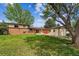 Expansive backyard with lush lawn, storage shed, patio, and mature trees, perfect for outdoor living and entertaining at 2990 S Jay St, Denver, CO 80227