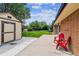 Backyard featuring a well-maintained lawn, a shed, and two red chairs on the patio at 2990 S Jay St, Denver, CO 80227