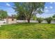 Spacious backyard featuring a lush green lawn, a storage shed, and mature trees at 2990 S Jay St, Denver, CO 80227