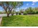 Expansive backyard with a lush green lawn, mature trees, and a white picket fence at 2990 S Jay St, Denver, CO 80227