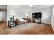 Finished basement featuring a comfortable seating area with a brown couch and a large TV at 2990 S Jay St, Denver, CO 80227