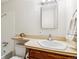 Bright bathroom features a single sink vanity, a framed mirror, and a shower-tub combination at 2990 S Jay St, Denver, CO 80227