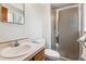 A cozy bathroom features a modern vanity with a white sink and a glass-enclosed shower at 2990 S Jay St, Denver, CO 80227