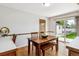 Bright dining area with hardwood floors, a wooden table and bench, and a sliding glass door to the backyard at 2990 S Jay St, Denver, CO 80227