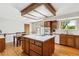 Spacious kitchen with a central island, wooden cabinets, and modern appliances at 2990 S Jay St, Denver, CO 80227
