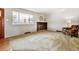 Bright living room featuring a brick fireplace, large window, and cozy armchair at 2990 S Jay St, Denver, CO 80227