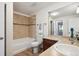 Well-lit bathroom featuring a shower/tub combo, toilet, and single sink vanity at 7680 Depew St # 1404, Arvada, CO 80003