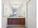 Bathroom with a single sink vanity and white cabinetry for ample storage at 7680 Depew St # 1404, Arvada, CO 80003