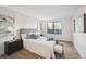 Comfortable bedroom with large window, neutral walls and light wood-look flooring at 7680 Depew St # 1404, Arvada, CO 80003