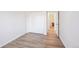 Spacious bedroom with closet, light wood-look flooring, and neutral paint at 7680 Depew St # 1404, Arvada, CO 80003