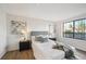 Cozy bedroom with a padded headboard, two side tables, and a window with natural light at 7680 Depew St # 1404, Arvada, CO 80003