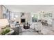 Bright living room features a fireplace, neutral walls, sleek flooring, and a sliding glass door to a balcony at 7680 Depew St # 1404, Arvada, CO 80003