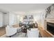 Cozy living room featuring a fireplace, neutral decor, and plenty of natural light at 7680 Depew St # 1404, Arvada, CO 80003