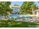 Inviting community pool with lounge chairs surrounded by mature trees and well-maintained landscaping at 7680 Depew St # 1404, Arvada, CO 80003