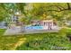 Beautiful community pool surrounded by mature trees and lush landscaping at 7680 Depew St # 1404, Arvada, CO 80003