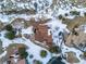 Aerial view of a house surrounded by snow-covered landscape and mature trees at 10895 Pheasant Run, Littleton, CO 80125