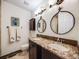 Bathroom with granite countertops, dual sinks, and custom mirrors at 10895 Pheasant Run, Littleton, CO 80125