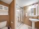 Cozy bathroom featuring a walk-in shower and vanity with a pedestal sink at 10895 Pheasant Run, Littleton, CO 80125
