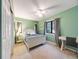 A green bedroom with a ceiling fan and built in desk at 10895 Pheasant Run, Littleton, CO 80125