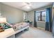 Bedroom with a double bed, large window, and grey walls at 10895 Pheasant Run, Littleton, CO 80125